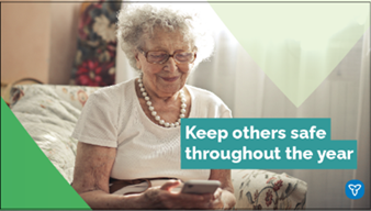 Senior woman smiling while looking at her phone. The text reads: Keep others safe throughout the year.