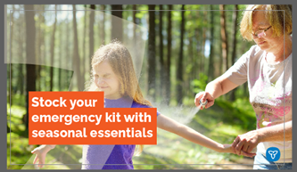 Adult applying bug spray to child, both standing on a path in a forest, trees and foliage in the background.