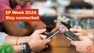 A group of people sitting at a table with their phones out.